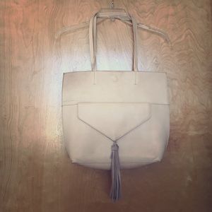 Ivory purse with removable clutch.